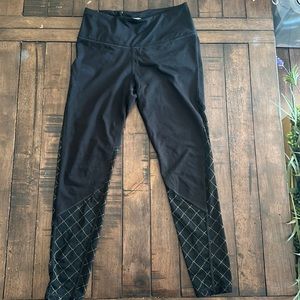 Black Victoria secret workout leggings, with mesh gold and black bottom